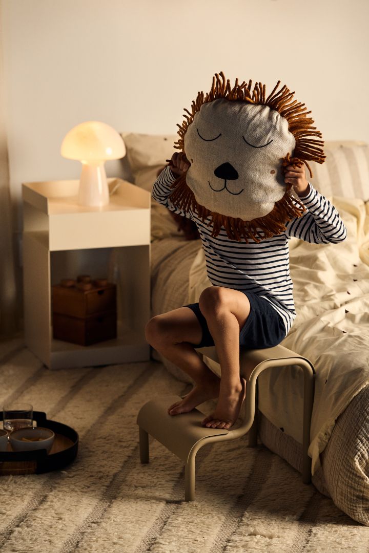 Lad personligheden komme frem når du skal indrette børneværelset, indfang interesser, yndlingsfigurer eller andre ting, som barnet kan lide så du virkelig ser hvem der bor der. Her holder et barn Safari puden fra Ferm Living, en pude med løvemotiv.